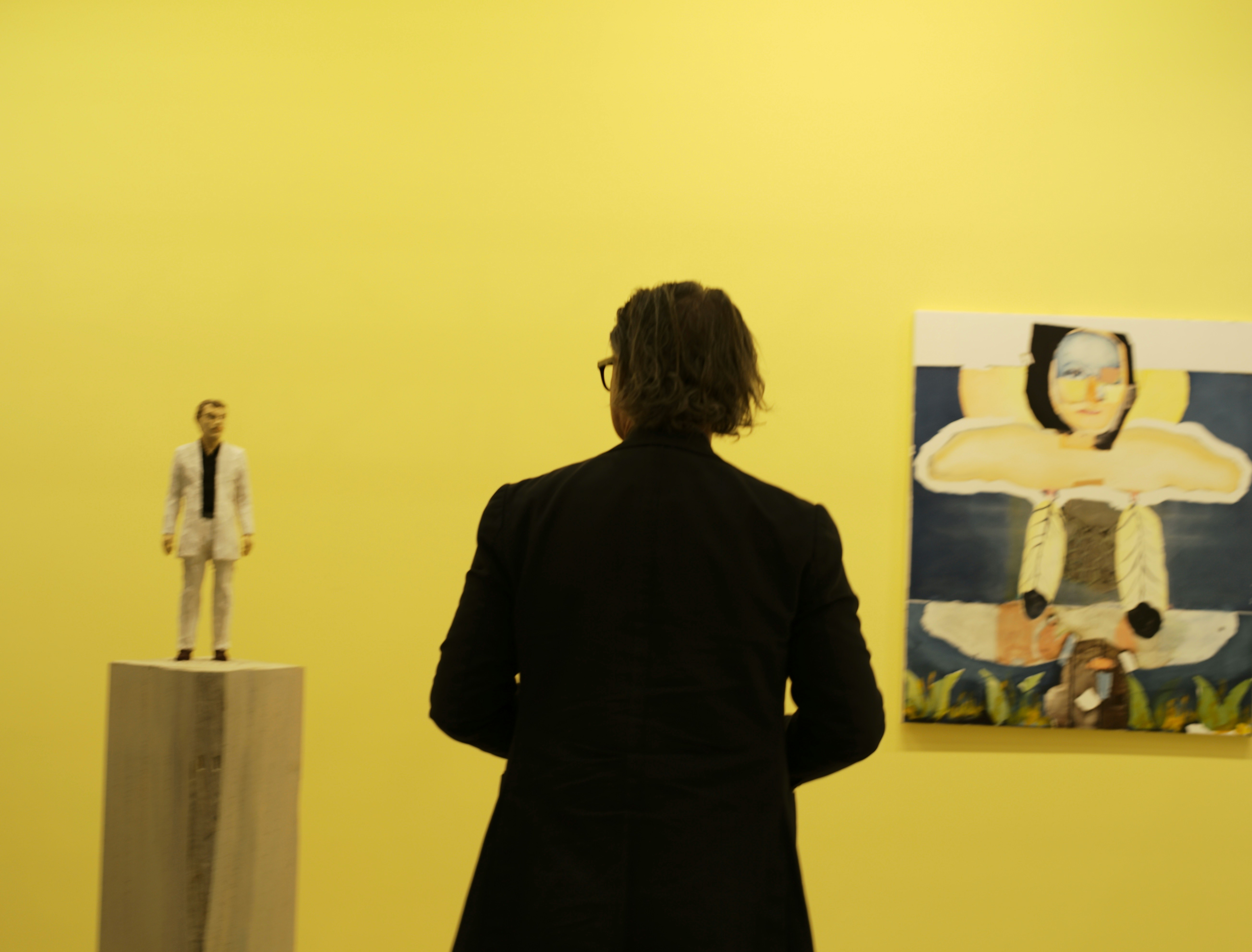 Elena Martinez, Founder and Curator of Lumina Gallery, standing in the gallery space